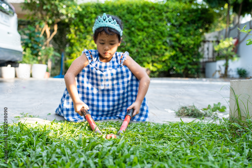 Child with grass shear on the grass Child with grass shear on the grass