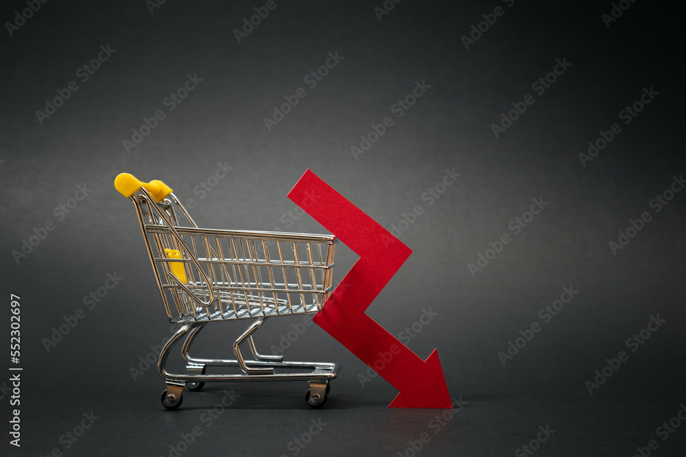 Drop in sales of a business. Decline in online orders of digital venture. Shopping cart with down arrow on black background