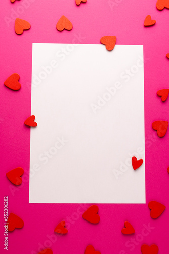 Vertical white rectangular copy space with red heart shapes on pink background © vectorfusionart