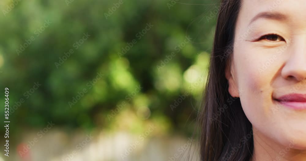Video of portrait of happy asian woman posing in garden Video of portrait of happy asian woman posing in garden