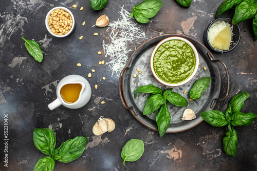Green basil pesto with italian recipe ingredients, Basil, olive oil, parmesan, garlic, pine nuts. banner, menu, recipe place for text, top view