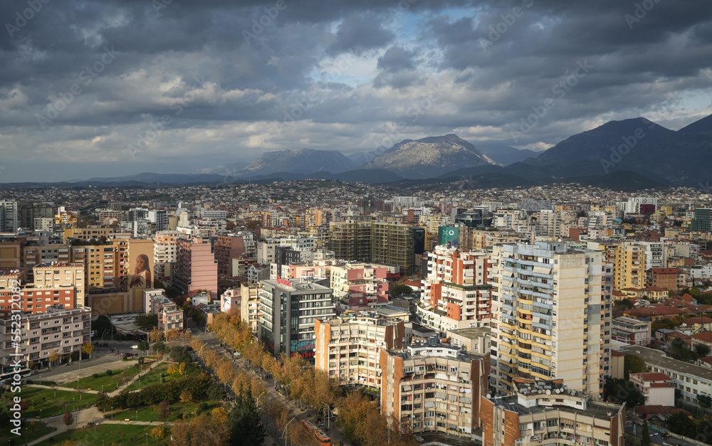 Tirana from above. Wide angle aerial view with the city center of Tirana city during a cloudy day in Albania, 2022.