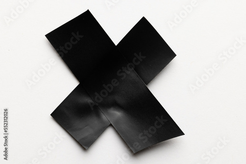 Cross shape black masking tape on white background
