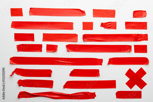 Ripped up pieces of red tape with copy space on white background