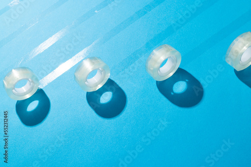 Rolls of transparent masking tape with copy space on blue background