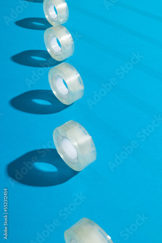 Rolls of transparent masking tape with copy space on blue background