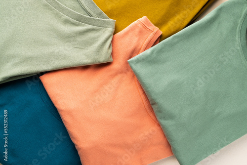 Close up of coloured tshirts and copy space on white background