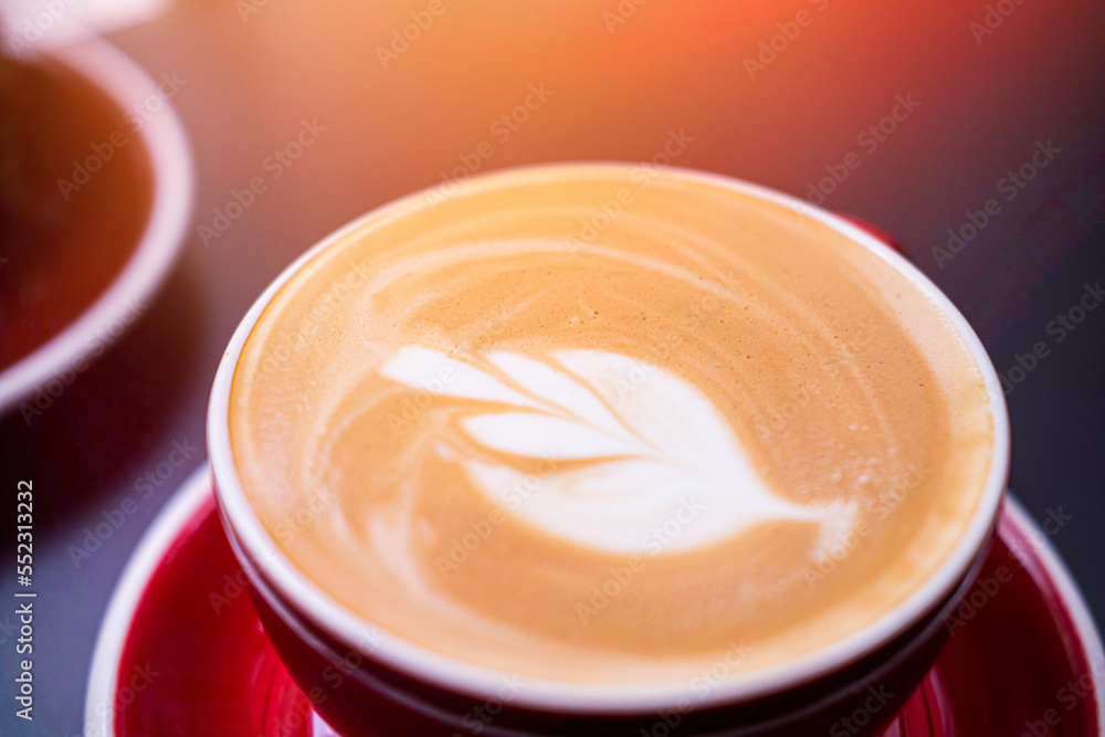 Coffee in a cup placed on a wooden table, close view Coffee in a cup placed on a wooden table, close view