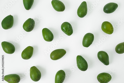 A lot of Avocados on white background. Flat lay, top view. Food concept.
