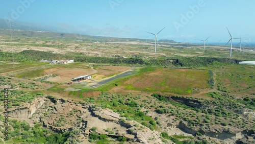 Aerial view of an aerodrome for aeromodelism in the southeast of Tenerife with some wind aerogenerators in the background. Drone shot photo