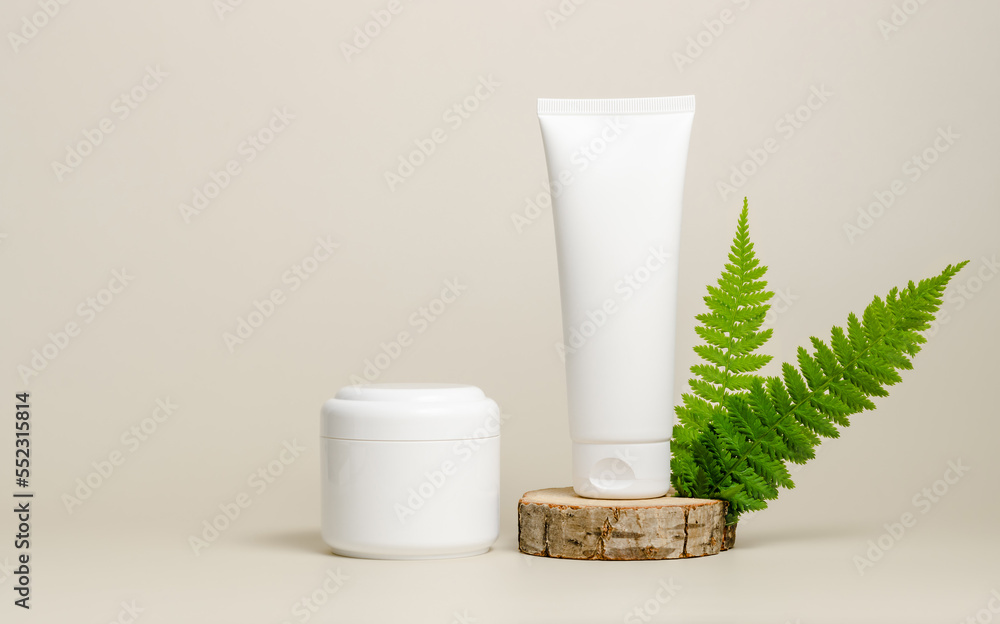 Cosmetic bottle containers mockup. Face cream on wooden podium with fern leaves. Natural organic beauty product concept. Face and body care concept Cosmetic bottle containers mockup. Face cream on wooden podium with fern leaves. Natural organic beauty product concept. Face and body care concept