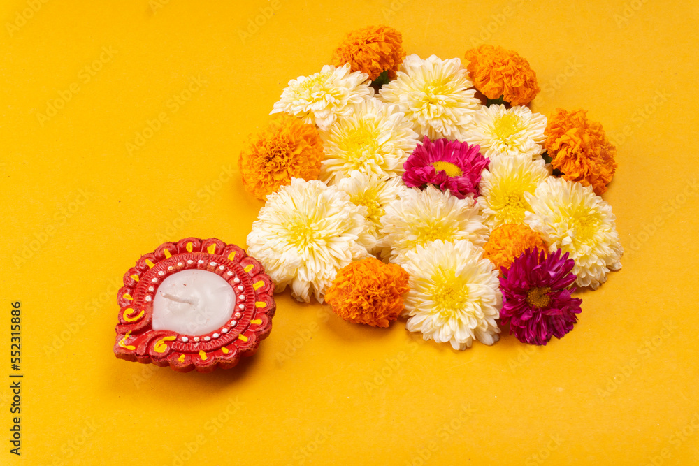 Flower rangoli for Diwali or Pongal made using marigold or zendu flowers and red rose petals. Indian Festival flower decoration. Flower rangoli for Diwali or Pongal made using marigold or zendu flowers and red rose petals. Indian Festival flower decoration.