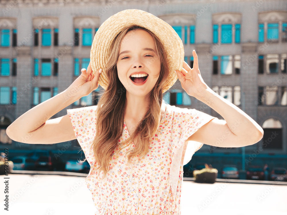 Young beautiful smiling hipster woman in trendy summer clothes. Sexy carefree woman posing on the street background at sunset. Positive model outdoors. Cheerful and happy In hat. Screams, shouts