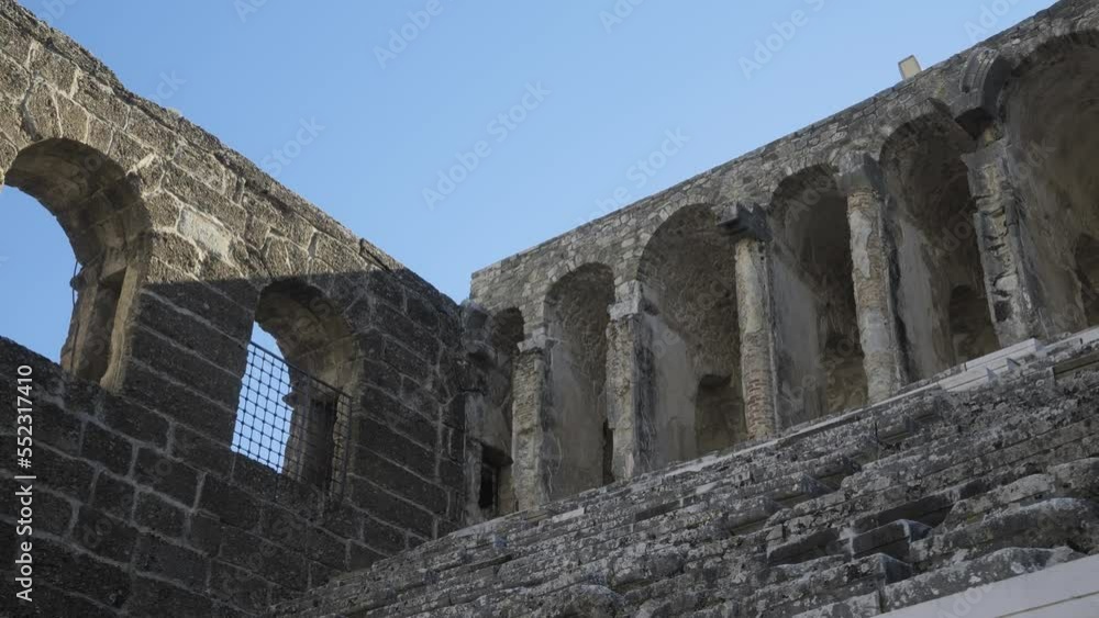 The camera moves along the steps of the seats of the ancient amphitheater with a view of the rear arches of the amphitheater. High quality 4k footage The camera moves along the steps of the seats of the ancient amphitheater with a view of the rear arches of the amphitheater. High quality 4k footage