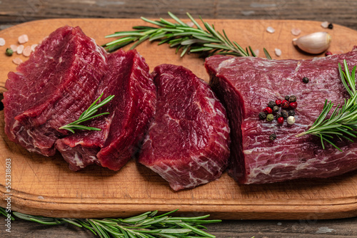 Raw beef meat steak Tenderloin fillet on a wooden background, banner, menu, recipe place for text, top view