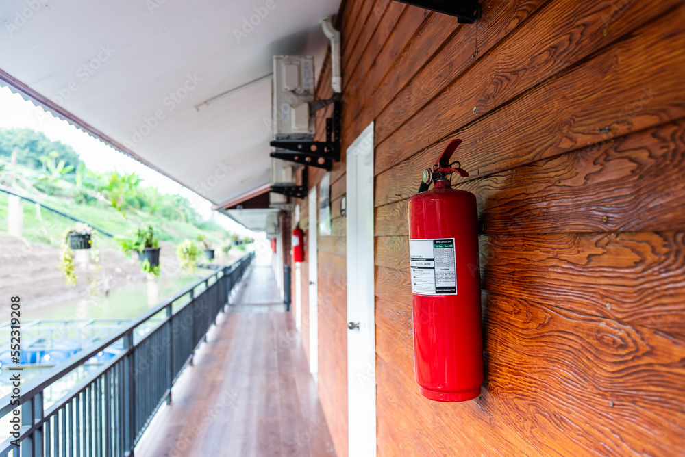 Fire extinguisher hanging at wooden wall. Fire extinguisher hanging at wooden wall.