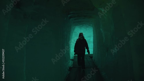 girl walking inside Rhone glacier in the canton of Valais in Switzerland photo