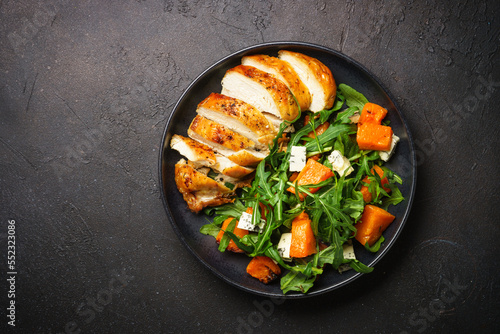 Chicken salad with pumpkin and arugula. Dash diet, keto diet meal. Top view image.