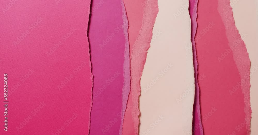Video of close up of torn pieces of pink and cream paper background Video of close up of torn pieces of pink and cream paper background