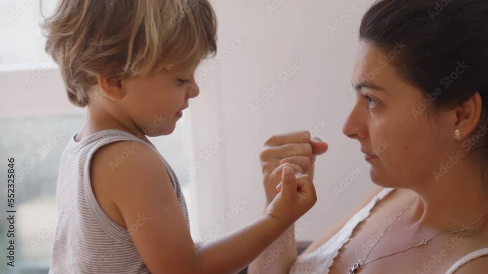 Mother and son doing pinky swear. Parent and child promise. Mom and kid relationship based on trust. Education commitment concept Mother and son doing pinky swear. Parent and child promise. Mom and kid relationship based on trust. Education commitment concept
