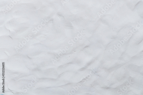 White or grey Plasticine textured background has a rough surface. By using your hand to knead it to flatten and have fingerprints attached. Used is House wall for background or website wallpaper. 