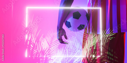 Midsection of african american male player with ball by illuminated plants and rectangle, copy space