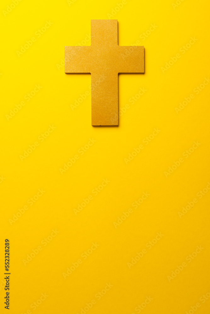 Fototapeta premium Composition of christian ash wednesday cross on yellow background with copy space