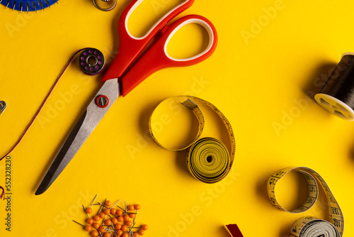 Composition of sewing equipment on yellow background with copy space