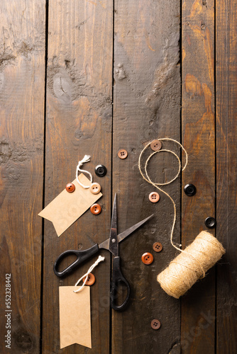 Composition of sewing equipment on wooden background