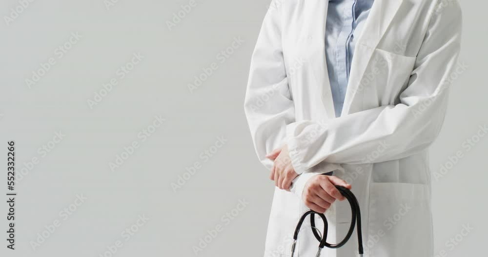 Video of midsection of caucasian female doctor holding stethoscope, with copy space Video of midsection of caucasian female doctor holding stethoscope, with copy space