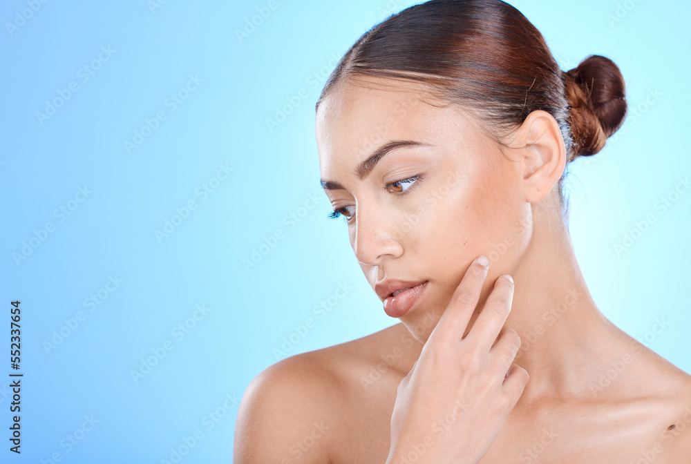 Naklejka premium Beauty, woman and skincare for a cosmetic treatment on a blue studio background for health. Dermatology, skin care and female with facial wellness aesthetic on a mockup or copyspace backdrop