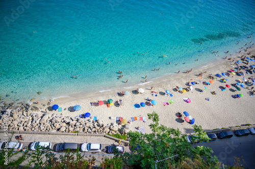Fototapeta Naklejka Na Ścianę i Meble -  View of the famous beach with colourful umbrellas in Tropea (Cal