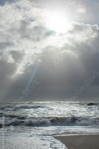 sea landscape with huge waves and a lightbeam in Sylt