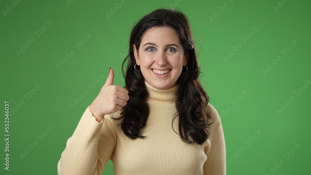 Portrait of thinking, smart puzzled pensive young hipster woman 20s comes up with ideas gives thumbs up isolated on green screen background studio portrait Portrait of thinking, smart puzzled pensive young hipster woman 20s comes up with ideas gives thumbs up isolated on green screen background studio portrait