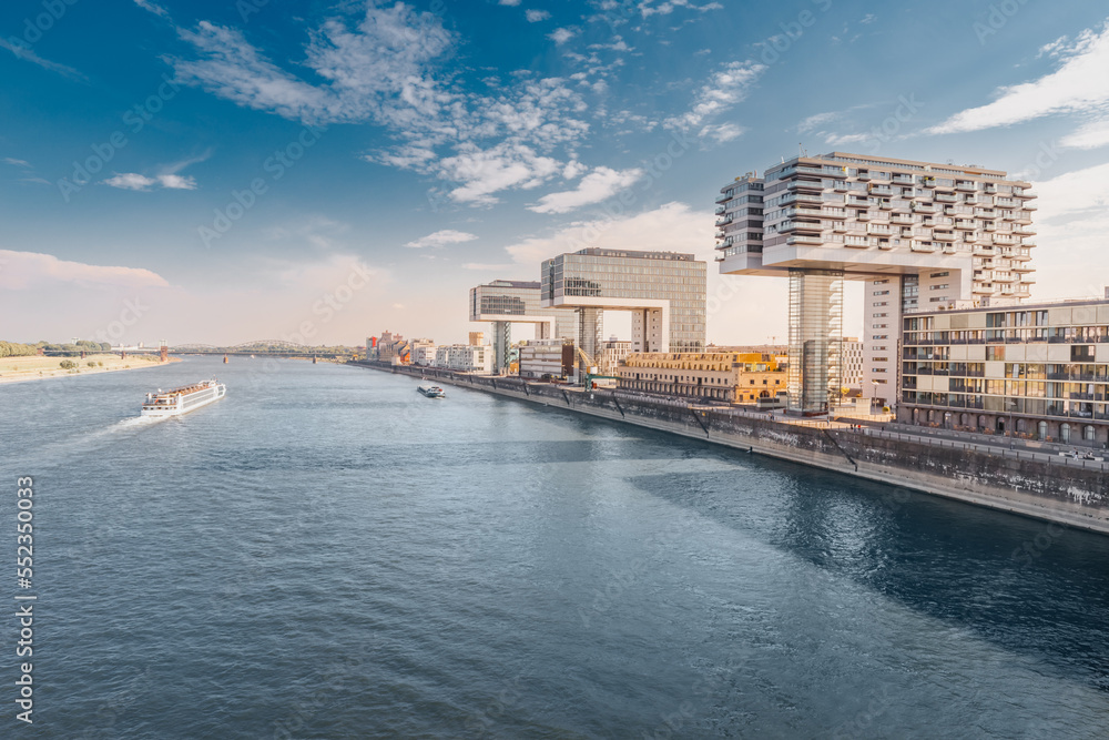 Scenic view of a Cologne cityscape skyline with Rhine river and modern residential buildings