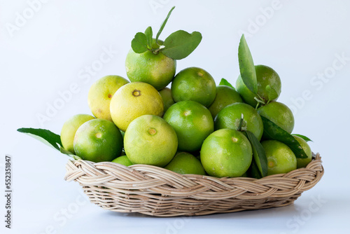 Fresh green oranges in basket , Fresh green oranges at market and shop for sell..Fresh green lemons, in basket , Fresh green lemons at market and shop for sell. photo