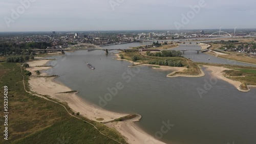 Wallpaper Mural Aerial view of inland cargo boats sailing past Nijmegen city on Waal river, with extremely low water levels. Water shortages and drought in Europe. 
 Torontodigital.ca