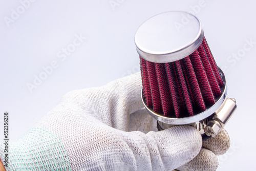 Conical chrome air filter with  - tuning accessory on a gray background