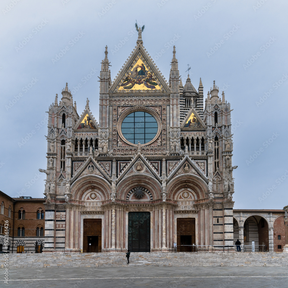 view of the front entrance and facade of the historic cathedral in Siena