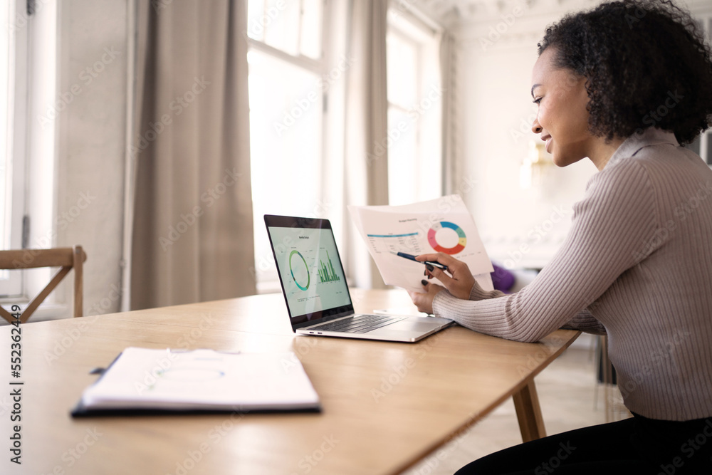 A woman designer over an application with graphs makes a report for the boss. Career in the office A female manager is working on an online startup. A woman designer over an application with graphs makes a report for the boss. Career in the office A female manager is working on an online startup.