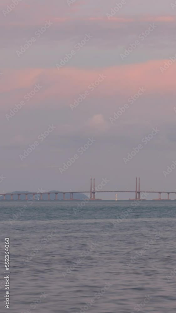 vertical Timelapse cloudy sunset ray over Penang Bridge over ocean connecting penang island with sunset vanilla sky time,famous landmark in malaysia vertical Timelapse cloudy sunset ray over Penang Bridge over ocean connecting penang island with sunset vanilla sky time,famous landmark in malaysia