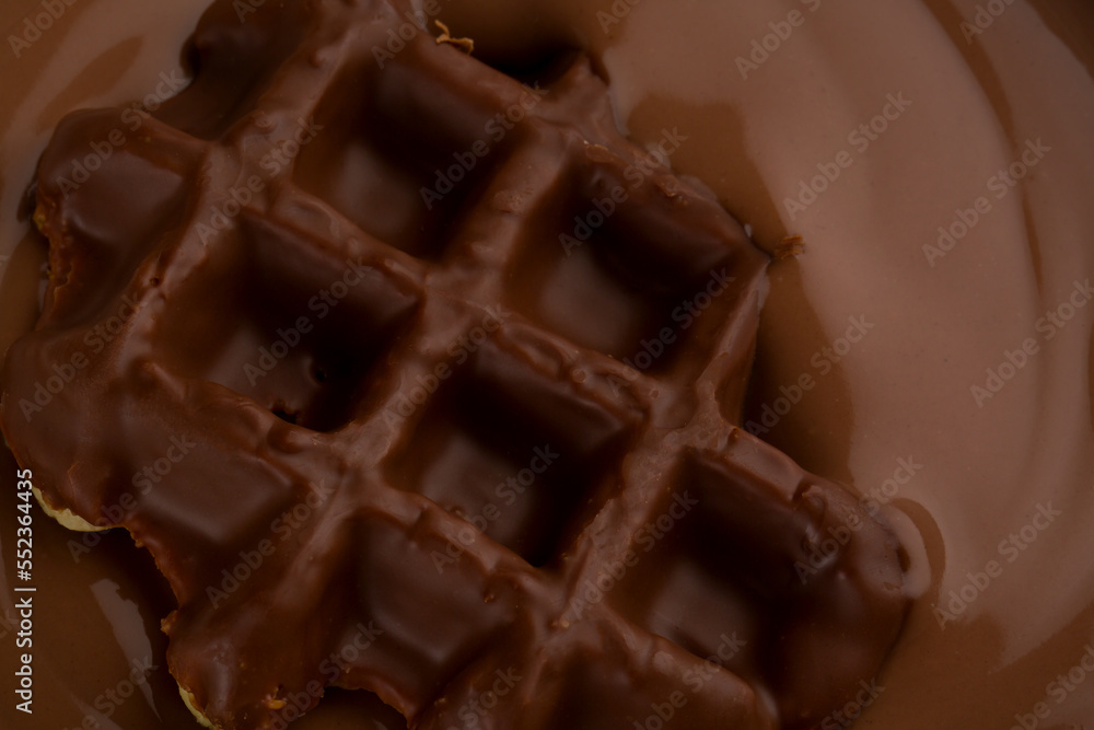Fototapeta premium Waffles with chocolate topping closeup