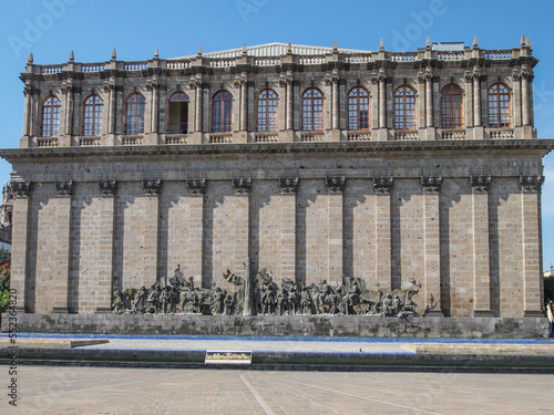 Rear wall of Degollado Theater with Frieze of the Founders of Guadalajara in bronze, work of Rafael Zamarripa, facing Plaza Fundadores, quarry wall, windows at top in historic center, Jalisco Mexico photo