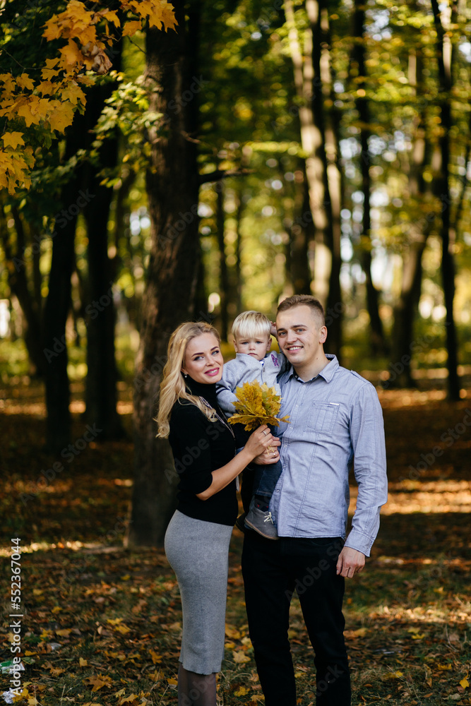 Fototapeta premium happy family playing and laughing in autumn park