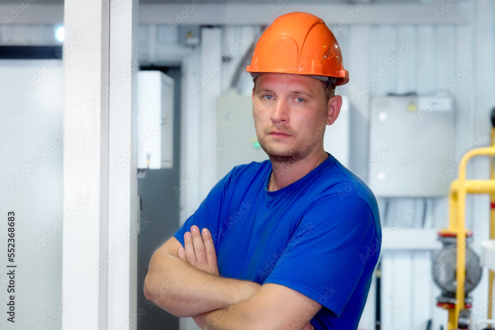 © SerPak - Portrait of engineer in construction helmet and work clothes on industrial background inside premises. Gas industry worker inside boiler room. Beginning of heating season in Europe.. © SerPak - Portrait of engineer in construction helmet and work clothes on industrial background inside premises. Gas industry worker inside boiler room. Beginning of heating season in Europe..