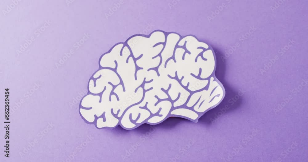Video of purple and white paper brain on purple background with copy space Video of purple and white paper brain on purple background with copy space