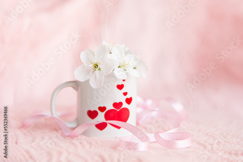 Fototapeta Naklejka Na Ścianę i Meble -  valentine's day concept. white cup for coffee with hearts on a pale pink background	