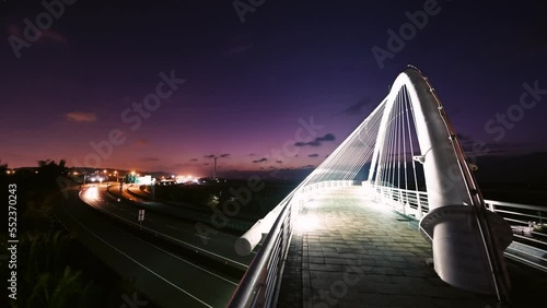 Beautiful and romantic colorful car light track. Night view of white bridge. Long exposure photography captures light trail images. Harp Bridge, Xiangshan District, Hsinchu County. photo