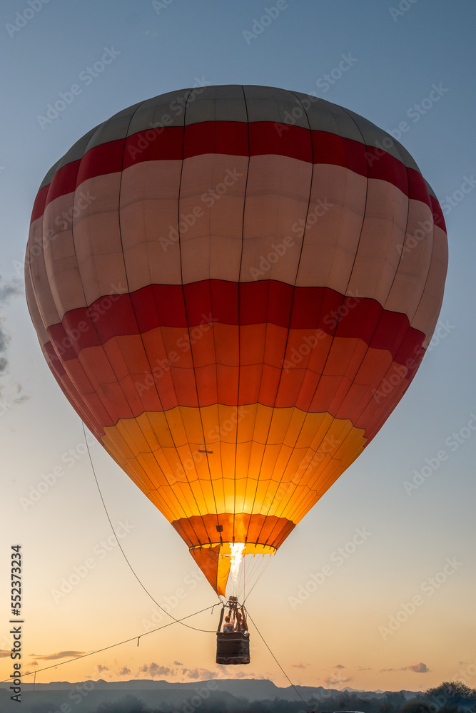 Fototapeta premium Air balloon in the evening sky. Upright photo.