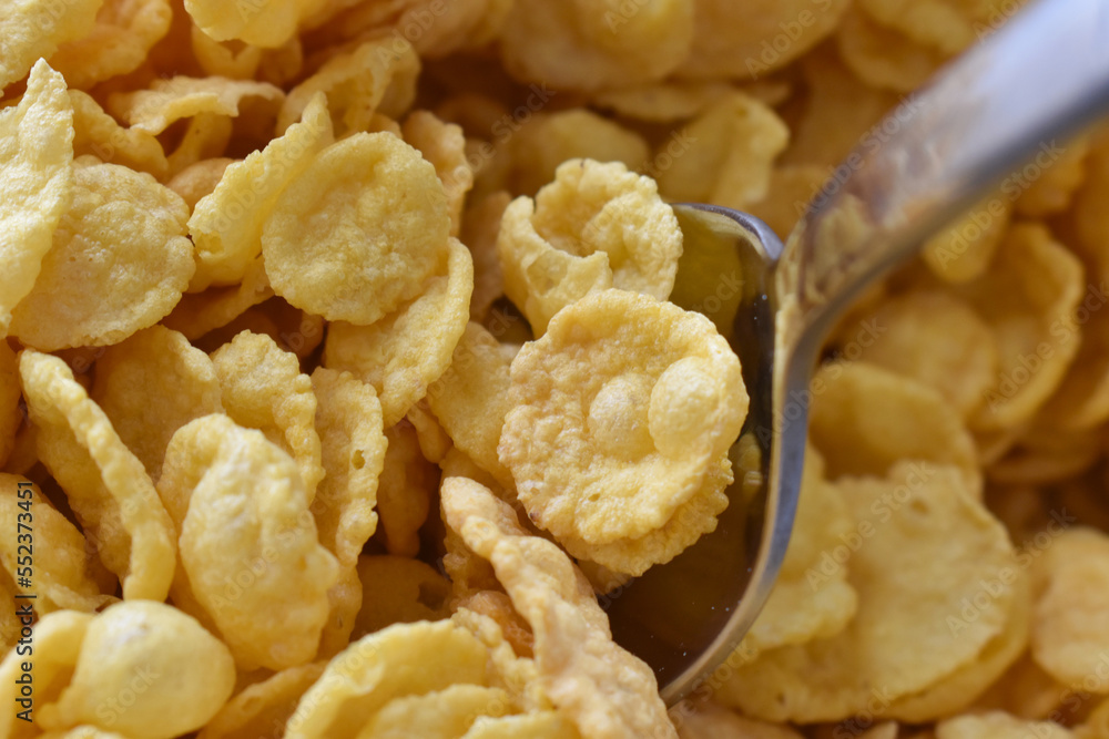Cornflakes on spoon. Cereal background. Healthy breakfast concept. Cornflakes on spoon. Cereal background. Healthy breakfast concept.